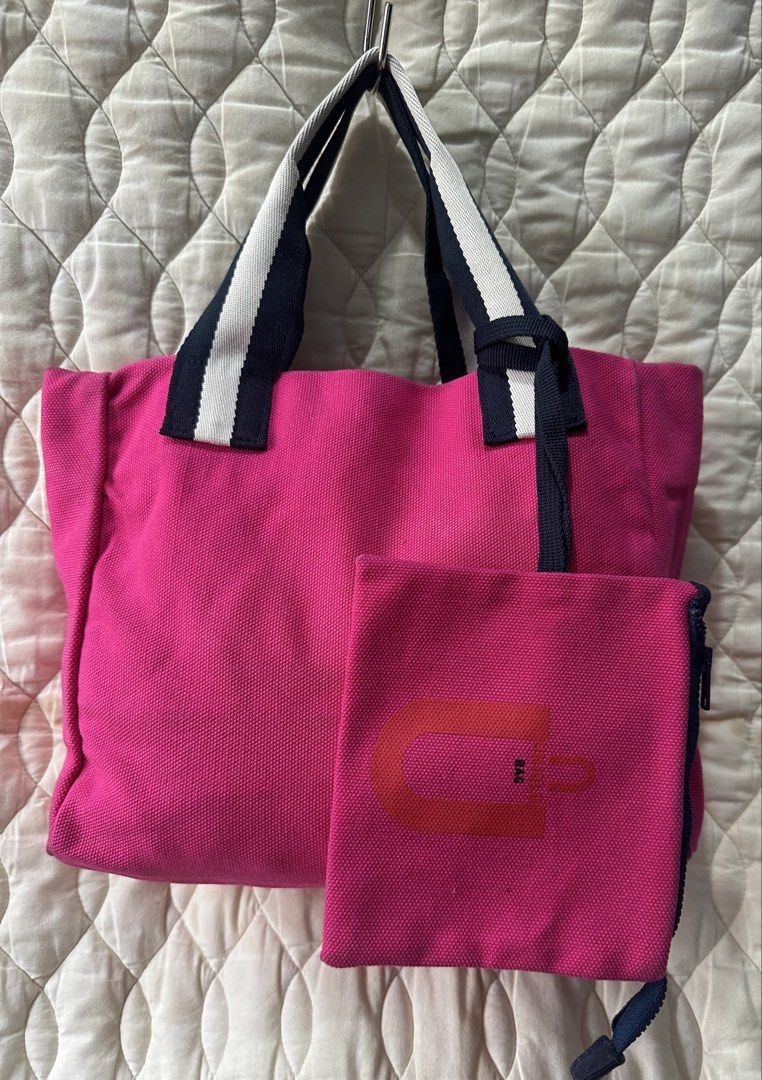 Uniqlo U Canvas Hand Bag Pink (Category: Tote Bags) located in Santa Rosa. Submitted by esplanamur03635 (Listing ID 1470689130, Image 1). Description: - Brand: Uniqlo U - Color: Bright pink canvas with navy and white striped handles - Includes: Matching zippered pouch attached with a strap wide room - Interior: Open top organizational slip pockets along the sides - Material: Sturdy denim like fabric - Size: Practical carryall size, perfect for da