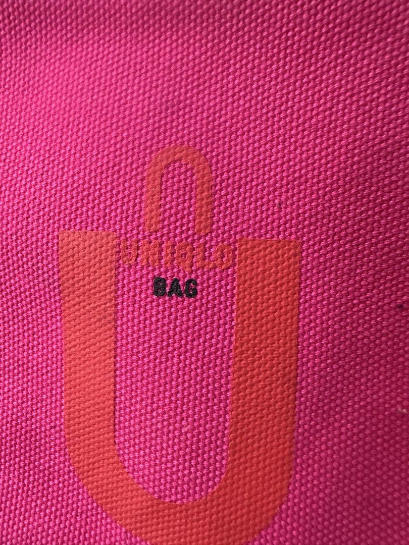 Uniqlo U Canvas Hand Bag Pink (Category: Tote Bags) located in Santa Rosa. Submitted by esplanamur03635 (Listing ID 1470689130, Image 3). Description: - Brand: Uniqlo U - Color: Bright pink canvas with navy and white striped handles - Includes: Matching zippered pouch attached with a strap wide room - Interior: Open top organizational slip pockets along the sides - Material: Sturdy denim like fabric - Size: Practical carryall size, perfect for da