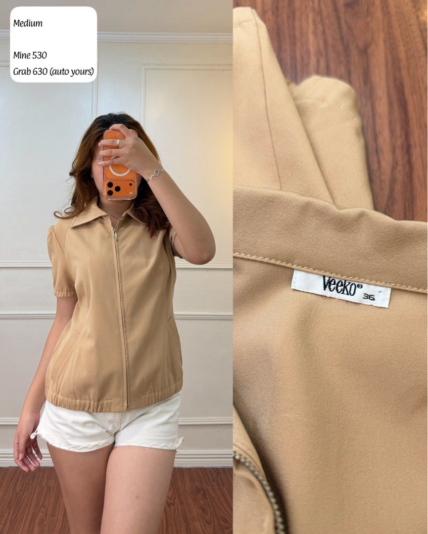 Veeko Beige Zip-Up Collar Top Size 36 (Category: Blouses) located in Manila. Submitted by angelll0123 (Listing ID 1470699486, Image 1). Description: - Brand: Veeko - Size: 36 (Small) - Color: Neutral beige (earth tone) - Details: Structured collar, full front zipper with silver hardware, short sleeves - Functional: Includes two front pockets and an elasticated hem - Styling: Easy to match with shorts or your favorite denim.