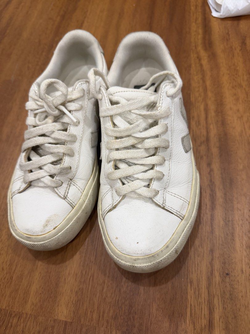 Veja Esplar White Leather Sneakers (Category: Sneakers) located in Makati City. Submitted by marowebg (Listing ID 1470627114, Image 3). Description: White leather sneakers from Veja. Grey suede heel tab with stamped logo. Classic lace-up front, rubber soles with moderate wear on the treads. Uppers have some scuffs and creasing from regular use. Soles show dirt buildup from walking outside. Comfortable daily wear shoes. Just needs cleaning but nev