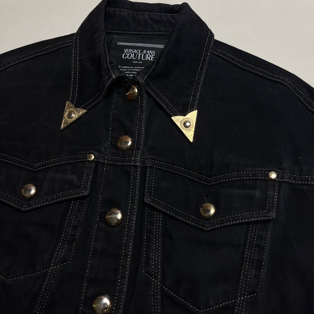 Versace Jeans Couture Black Cropped Denim Jacket (Category: Coats, Jackets and Outerwear) located in Caloocan City. Submitted by achilles_grails (Listing ID 1470583731, Image 3). Description: - Brand: Versace Jeans Couture - Color: Black denim - Fit: Cropped fit with raw frayed hem - Hardware: Gold-tone hardware with engraved metal buttons - Special Details: Decorative gold tips on collar points, contrast topstitching - Pockets: Two chest pockets