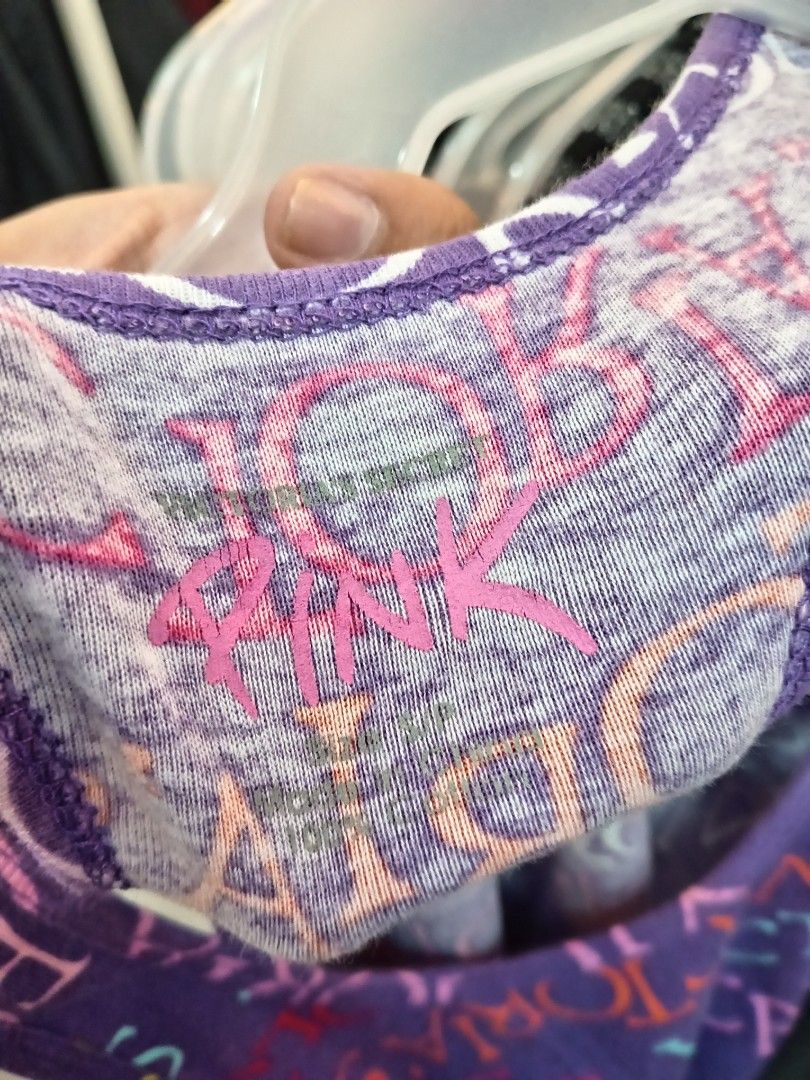 Victoria's Secret (Category: Sleeveless) located in Manila. Submitted by sonny2k (Listing ID 1470678157, Image 3). Description: - Brand: Victoria's Secret PINK - Color: Purple with all-over colorful logo print - Style: Racerback with scoop neck - Size: Small - Material: 100% Cotton (soft & breathable) - Condition: Great for casual everyday wear.