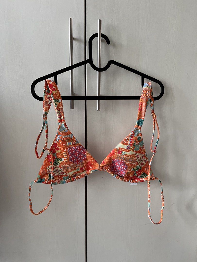 Vida Swimwear Orange Patterned Two-Piece Bikini Set Size M (Category: Bikinis & Swimsuits) located in Quezon City. Submitted by blesshie_ (Listing ID 1470581485, Image 3). Description: - Brand: Vida Swimwear - Style: Two-piece bikini with vibrant orange patchwork and floral print - Top: Triangle top with thick, adjustable straps - Bottoms: Trendy high-cut style - Size: Medium (tag attached) - Condition: Brand new, unworn with tags still intact - 