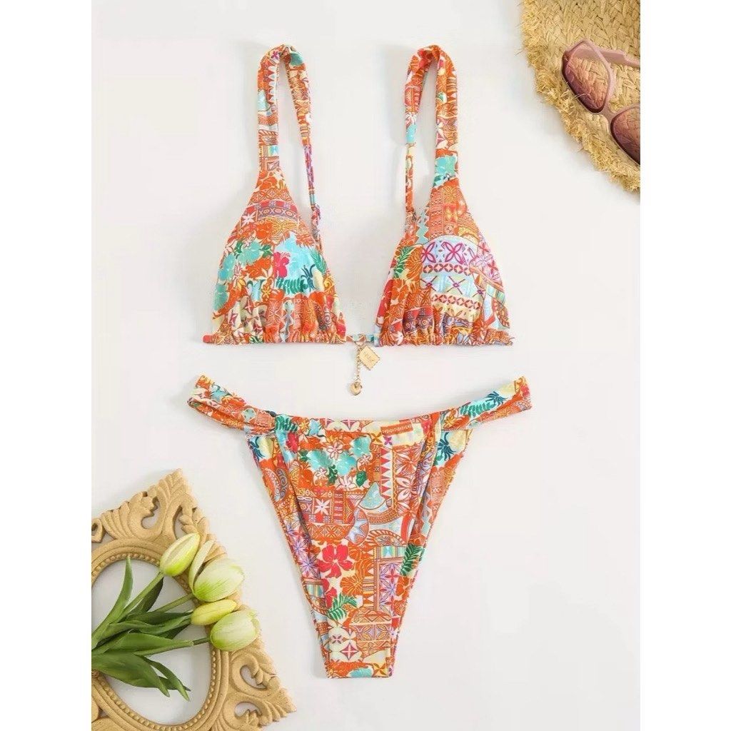 Vida Swimwear Orange Patterned Two-Piece Bikini Set Size M (Category: Bikinis & Swimsuits) located in Quezon City. Submitted by blesshie_ (Listing ID 1470581485, Image 1). Description: - Brand: Vida Swimwear - Style: Two-piece bikini with vibrant orange patchwork and floral print - Top: Triangle top with thick, adjustable straps - Bottoms: Trendy high-cut style - Size: Medium (tag attached) - Condition: Brand new, unworn with tags still intact - 