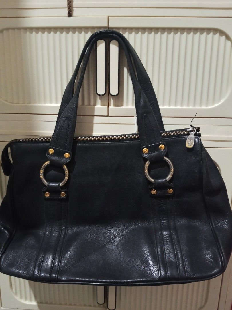 Vintage Authentic MCM Black Leather Tote Shoulder Bag. RUSH SALE (Category: Luxury Bags & Wallets) located in Adams. Submitted by red__lee (Listing ID 1470672097, Image 2). Description: Feel free to message me if you have any questions :>> -No broken zippers -Clean interior/no issues Flaws to note: • Leather piping on the bottom corners is split/exposed. • Normal vintage corner rubs, surface scuffs, and slight color fading. • Gold hardware shows 
