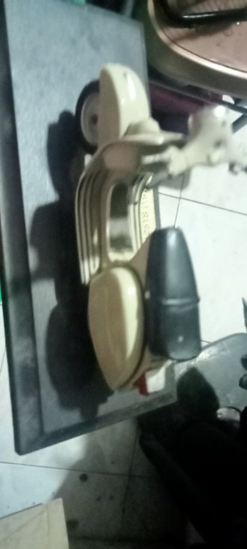 Vintage Beige Scooter Model Toy (Category: Kids Toys) located in Paranaque City. Submitted by dimaguilaa24827 (Listing ID 1470653834, Image 1). Description: - Miniature beige scooter replica with classic retro design - Features a contrasting black seat, handlebars, and realistic wheels - Perfect compact size for desks, shelves, or display cabinets - Great collectible item or gift for scooter enthusiasts - Item has been in storage and just needs a