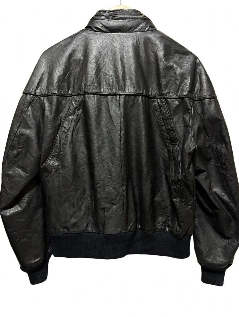 Vintage Black Leather Bomber Jacket Stand Collar (Category: Coats, Jackets and Outerwear) located in Quezon City. Submitted by kimzxc_536 (Listing ID 1470726046, Image 2). Description: - Style: Black leather bomber jacket - Fit: Regular fit with paneled leather detailing - Collar: High stand collar with snap button closures - Pockets: Two front chest pockets with secure zippers - Details: Ribbed cuffs and hem with natural grain texture - Material