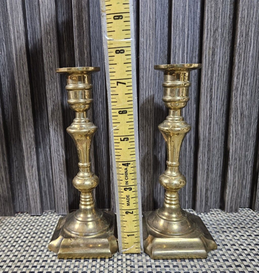 Vintage Brass Candlestick Holders Pair (Category: Vintage Collectibles) located in Rizal. Submitted by cherry_garcia (Listing ID 1470628220, Image 2). Description: - Material: Solid brass with square bases - Height: Approx. 7.5 inches tall - Design: Classic turned design with a satisfying weight - Condition: Clean, with minor patina and slight tarnish from age - Best for: Dinner table settings or mantelpiece decor - Inclusions: Sold as a pair.