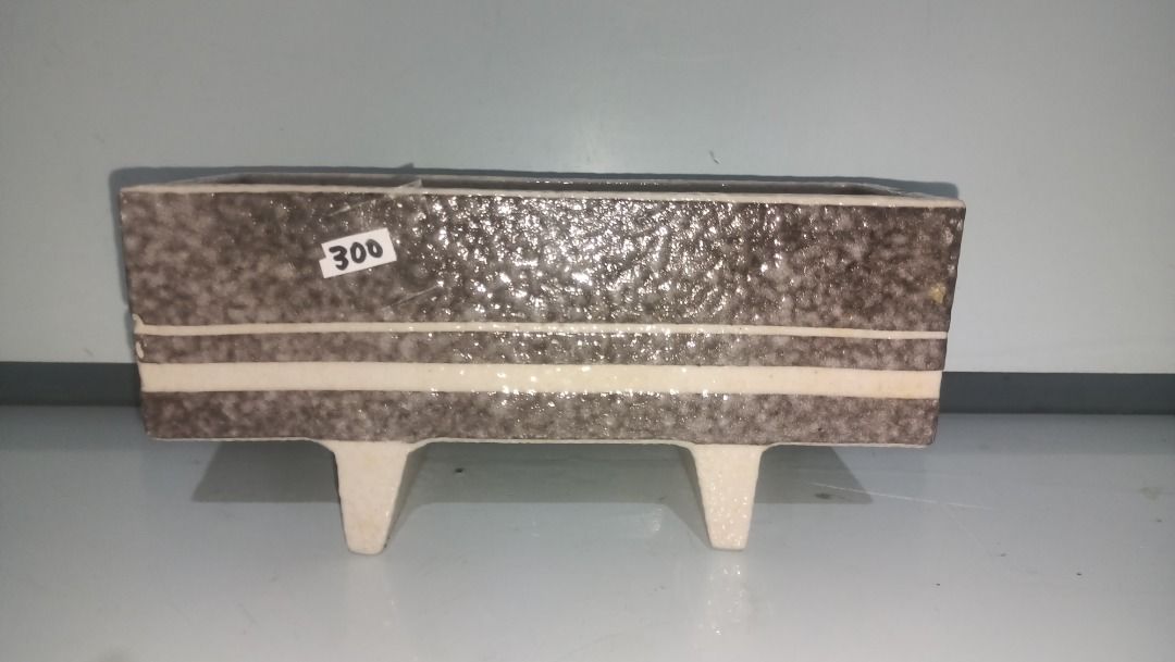 Vintage Ceramic Planter Pot Rectangular Brown Speckled with Feet (Category: Pots & Planters) located in Munoz. Submitted by larryc1212 (Listing ID 1470631823, Image 1). Description: - Type: Rectangular ceramic planter pot - Design: Textured brown speckled finish with white stripe accents - Size: Approximately 9 inches long - Features: Stands on two built-in feet, heavy and solid build - Condition: Minor dirt marks inside from previous use - Perfe