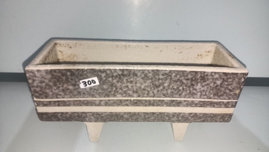 Vintage Ceramic Planter Pot Rectangular Brown Speckled with Feet (Category: Pots & Planters) located in Munoz. Submitted by larryc1212 (Listing ID 1470631823, Image 2). Description: - Type: Rectangular ceramic planter pot - Design: Textured brown speckled finish with white stripe accents - Size: Approximately 9 inches long - Features: Stands on two built-in feet, heavy and solid build - Condition: Minor dirt marks inside from previous use - Perfe