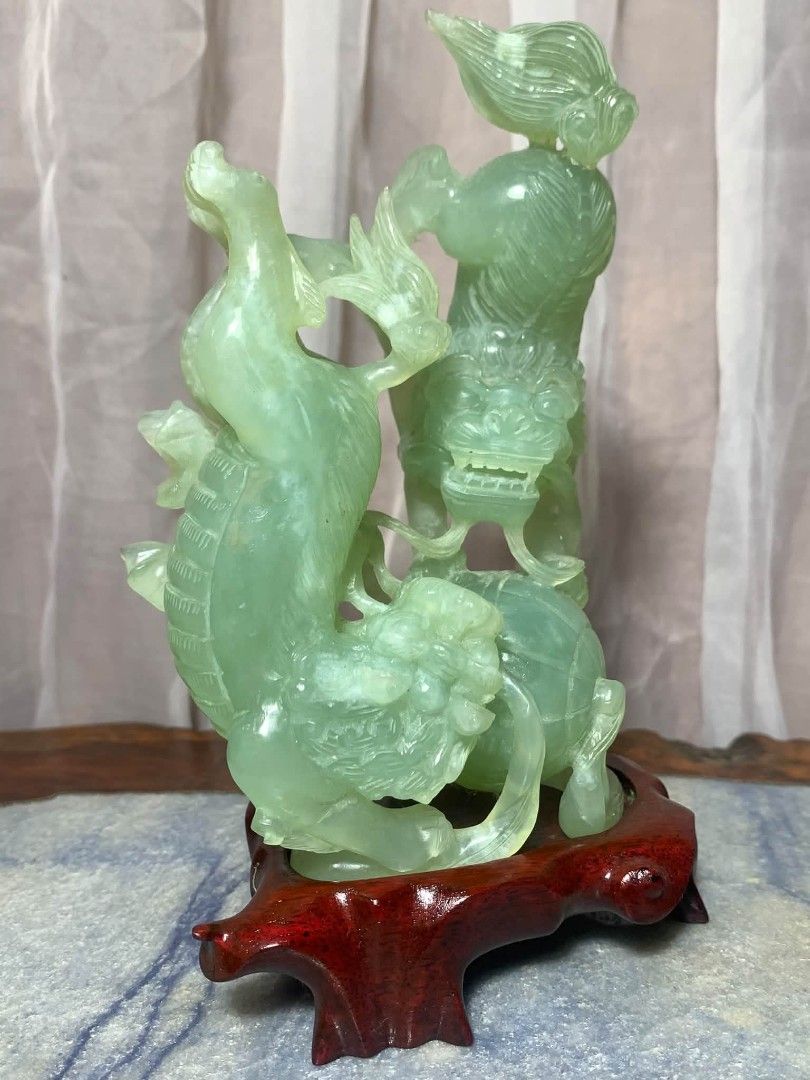 Vintage Chinese Stone Carving (Category: Vintage Collectibles) located in Davao. Submitted by antiquesandvintagestuffsPH (Listing ID 1470621778, Image 1). Description: Chinese Jade Foo Dog Hand carved Stone Statue w Wooden Base - Stunning Chinese carved jade stone statue on a custom wooden base. Beautiful translucent light green color. Features a Qilin (mythical dragon-like creature) playing with a ball. Measurement : 7.25inch height / 4.25inch l