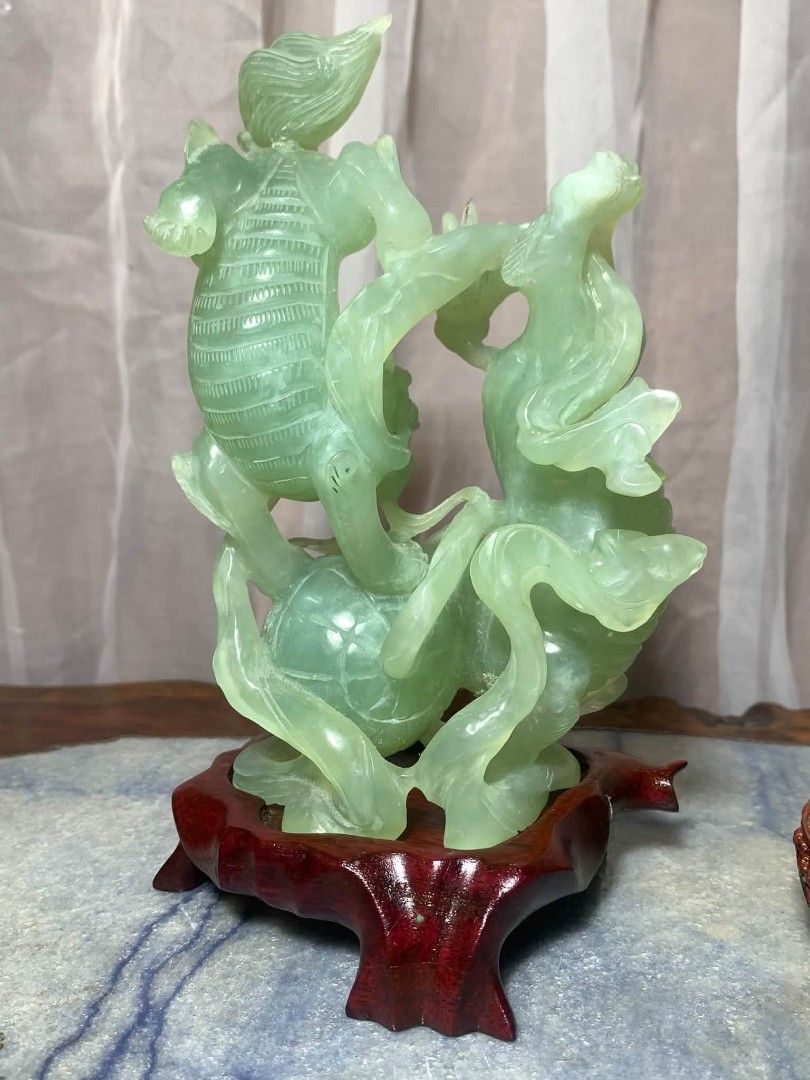 Vintage Chinese Stone Carving (Category: Vintage Collectibles) located in Davao. Submitted by antiquesandvintagestuffsPH (Listing ID 1470621778, Image 3). Description: Chinese Jade Foo Dog Hand carved Stone Statue w Wooden Base - Stunning Chinese carved jade stone statue on a custom wooden base. Beautiful translucent light green color. Features a Qilin (mythical dragon-like creature) playing with a ball. Measurement : 7.25inch height / 4.25inch l