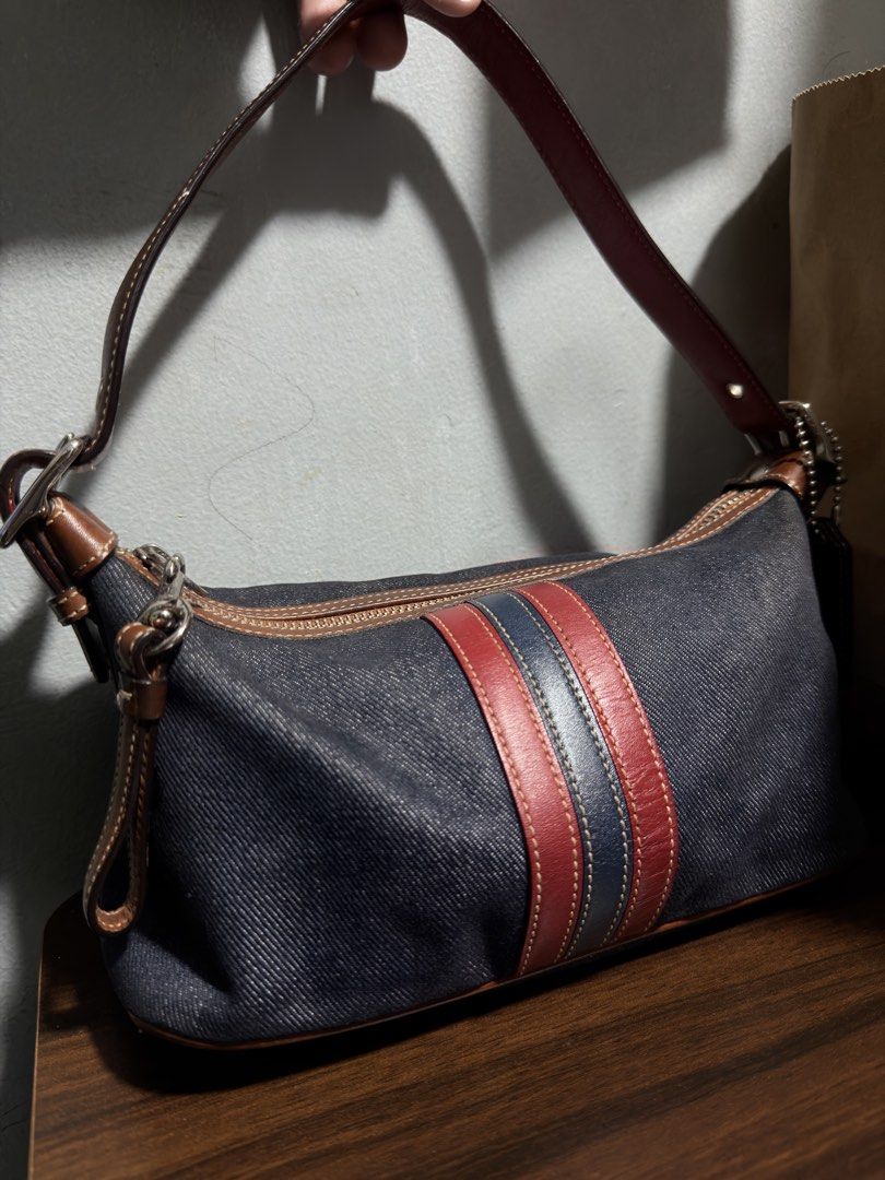 Vintage Coach Mini Bag (Category: Luxury Bags & Wallets) located in Mandaluyong City. Submitted by marsemars (Listing ID 1470663103, Image 2). Description: - Authentic Coach shoulder bag in stylish dark denim fabric - Eye-catching brown and red leather stripes down the front - Secure zip top closure and convenient outer zippered pocket - Adjustable brown leather strap with buckle for a custom fit - Elegant silver-tone hardware and zippers - Inter