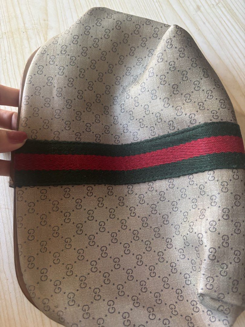 Vintage Gucci Micro GG Web Stripe Clutch Pouch (Category: Luxury Bags & Wallets) located in Rizal. Submitted by riri.rarapreloved (Listing ID 1470627882, Image 3). Description: -vintage Gucci clutch pouch - Classic beige micro GG monogram canvas with iconic green and red web stripe - Premium brown leather trim and tab closure with embossed logo - Convenient interior zip pocket inside the main compartment - Condition: Shows minor scuffs on the lea
