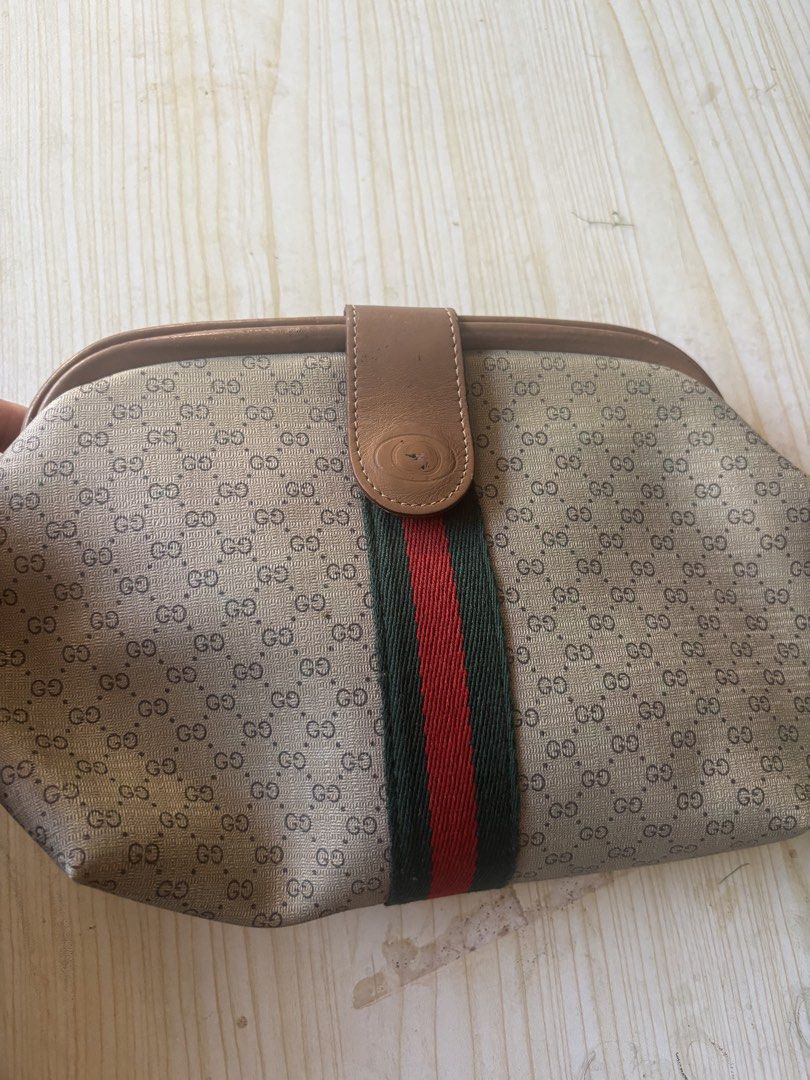 Vintage Gucci Micro GG Web Stripe Clutch Pouch (Category: Luxury Bags & Wallets) located in Rizal. Submitted by riri.rarapreloved (Listing ID 1470627882, Image 1). Description: -vintage Gucci clutch pouch - Classic beige micro GG monogram canvas with iconic green and red web stripe - Premium brown leather trim and tab closure with embossed logo - Convenient interior zip pocket inside the main compartment - Condition: Shows minor scuffs on the lea