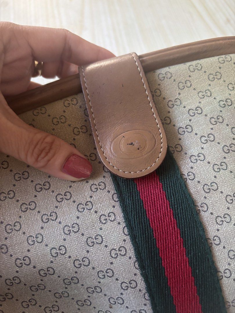 Vintage Gucci Micro GG Web Stripe Clutch Pouch (Category: Luxury Bags & Wallets) located in Rizal. Submitted by riri.rarapreloved (Listing ID 1470627882, Image 2). Description: -vintage Gucci clutch pouch - Classic beige micro GG monogram canvas with iconic green and red web stripe - Premium brown leather trim and tab closure with embossed logo - Convenient interior zip pocket inside the main compartment - Condition: Shows minor scuffs on the lea