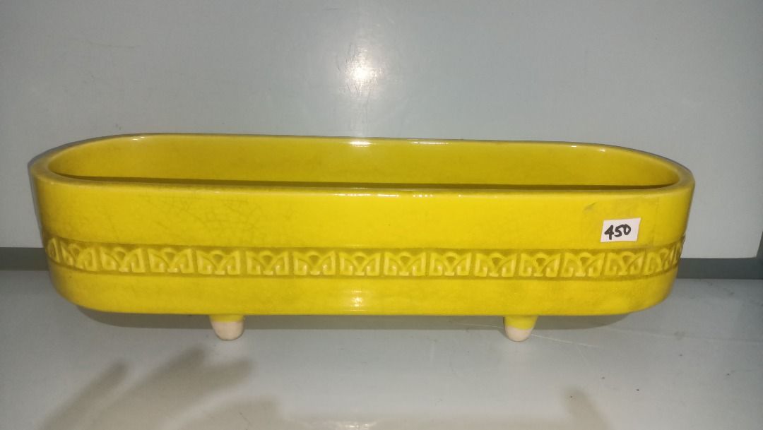 Vintage Ikebana yellow rectangular ceramic planter pot with footed base (Category: Pots & Planters) located in Munoz. Submitted by larryc1212 (Listing ID 1470630218, Image 2). Description: - Color: Bright yellow ceramic with a textured geometric pattern - Shape: Rectangular with rounded ends, raised on 4 white feet - Size: Approx. 16 inches long and 4.25 inches deep - Condition: Good solid piece with normal glaze crazing - Versatile: Perfect for 