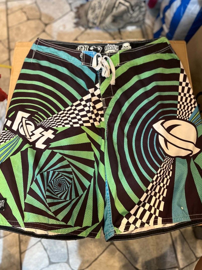 Vintage LOST Interprises(Mayhem) (Category: Shorts) located in Manila. Submitted by temetrius_husslin (Listing ID 1470663127, Image 1). Description: SIZE: W38/L22/LO12 • Brand: Lost Enterprises (Mayhem) • Style: Psychedelic Spiral / Optical Illusion Board Shorts • Colorway: Psychedelic Green, Black, and Turquoise Blue mesh accents • Details: Front lace-up drawstring waist, classic skull/logo waistband branding, side pocket, and embroidered logo p