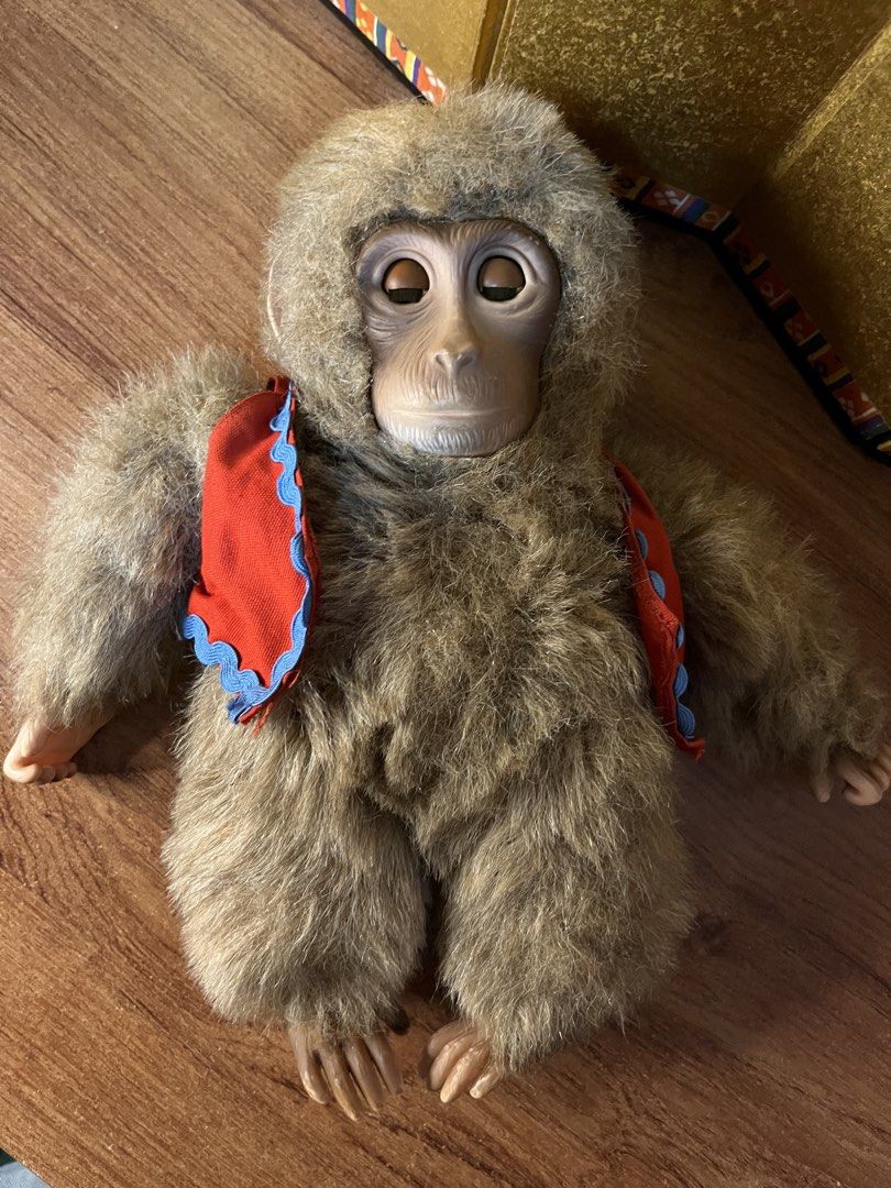 Vintage Monkey Plush Doll with Red Vest (Category: Plushies & Soft Toys) located in Gapan. Submitted by lunashop14 (Listing ID 1470637606, Image 2). Description: Furry plush monkey doll wearing a red vest with blue trim. Realistic vinyl face, hands, and feet with detailed fingers and toes. Expressive brown eyes. Soft brown fur coat. Cute collector's item or toy for monkey lovers..