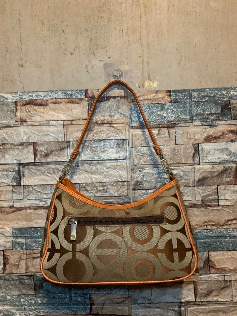 Vintage patterned shoulder bag in brown and orange (Category: Shoulder Bags) located in Pasay City. Submitted by bhibeboutique (Listing ID 1470724378, Image 2). Description: - Brown and orange patterned fabric shoulder bag with bold orange trim and corner patches - Secure top zipper closure with a comfortable single strap attached via sturdy metal hardware - Exterior back zip pocket for quick access to essentials - Stylish branded metal logo plat