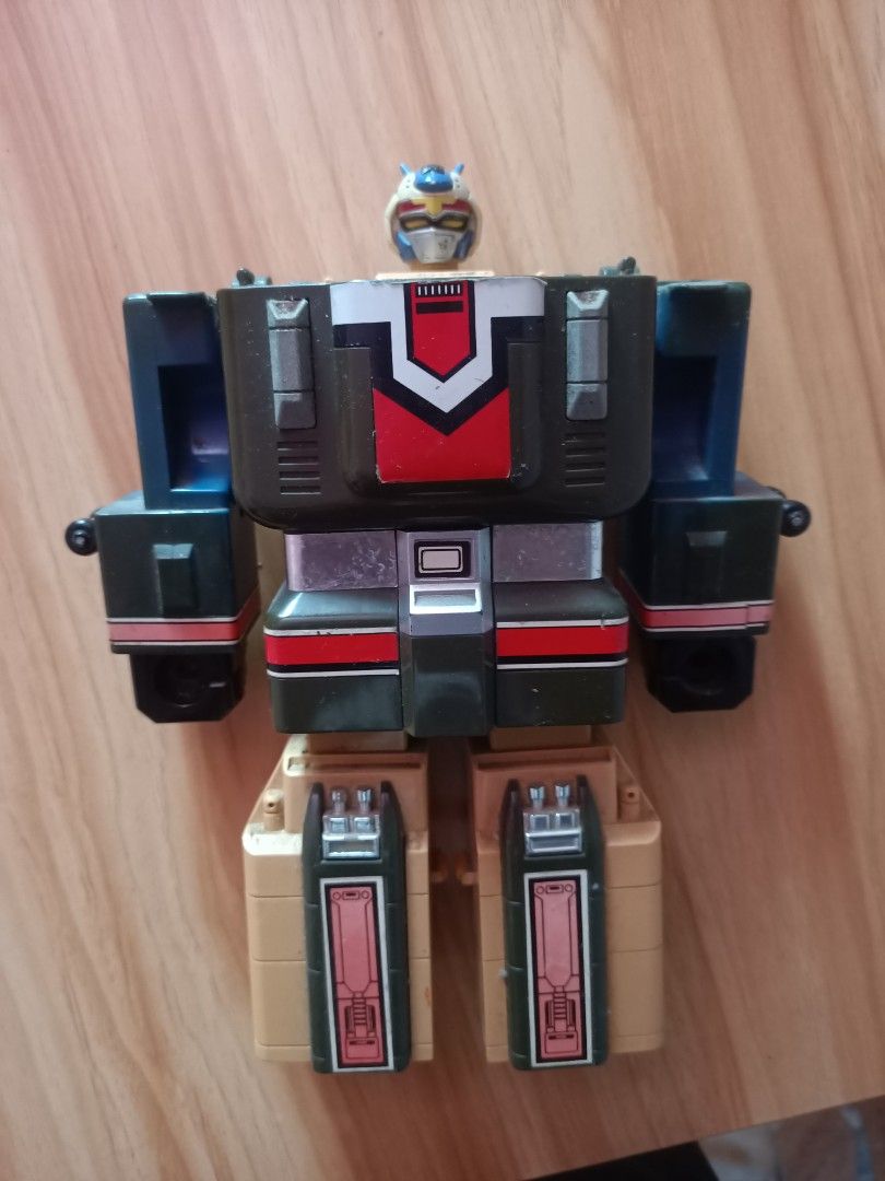 Vintage Retro Transforming Robot Action Figure (Category: Action & Battle Toys) located in Taguig. Submitted by grandfish_55ab5c (Listing ID 1470565559, Image 2). Description: - Vintage multi-colored transforming robot action figure - Features classic mechanical styling with movable parts - Shows minor dust, paint chipping, and surface wear from long-term storage - Perfect collectible display piece for retro toy enthusiasts - PM for more details 