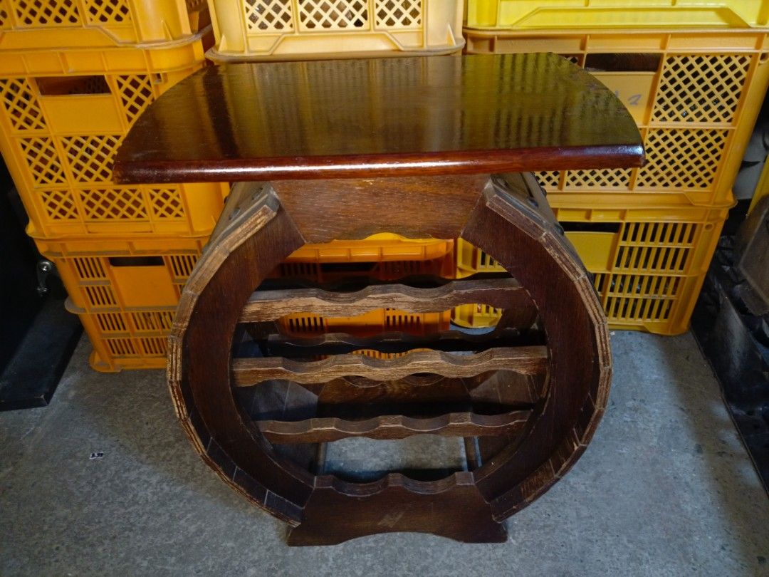 Vintage Wooden Round Barrel Wine Rack Table (Category: Tables & Sets) located in Valenzuela. Submitted by feel_lucky (Listing ID 1470653632, Image 3). Description: - Type: Round wooden wine rack with flat tabletop surface - Capacity: Holds multiple wine bottles horizontally - Design: Compact, freestanding, dark wood grain finish - Condition: Sturdy and ready to use, with minor surface scratches and edge wear on the top board - Ideal for: Small sp