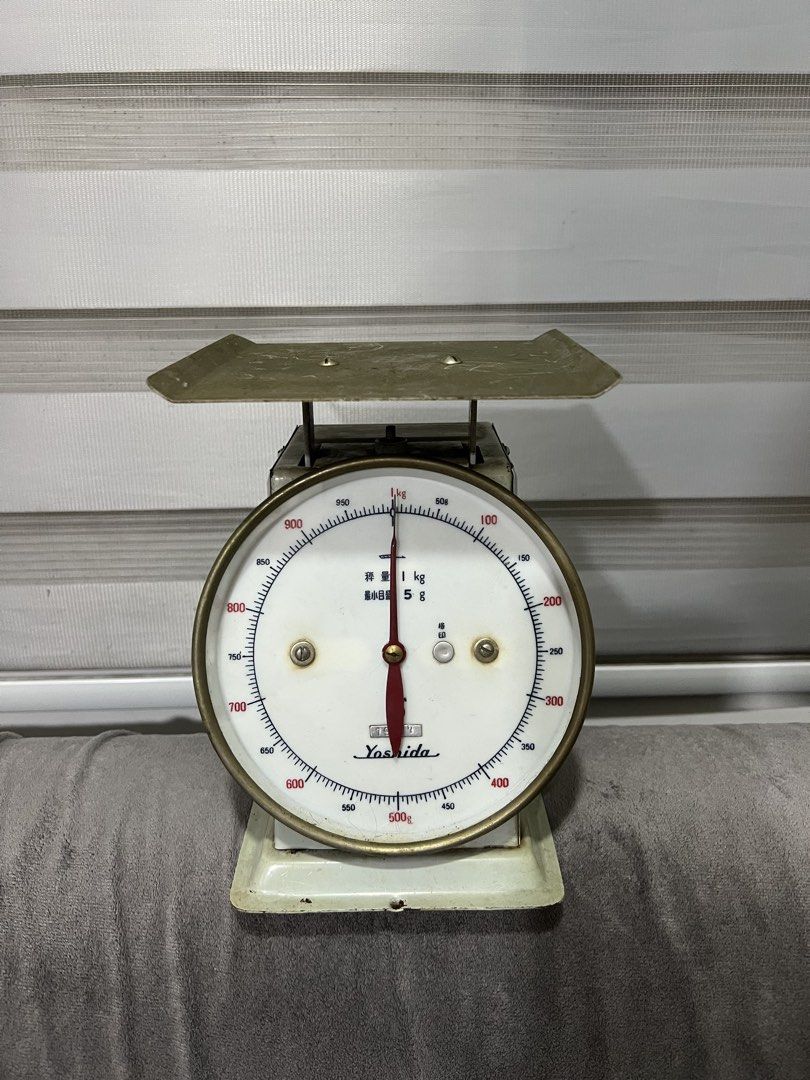 Vintage Yoshida Mechanical Kitchen Scale 1kg (Category: Cookware & Accessories) located in Las Pinas. Submitted by maple0305 (Listing ID 1470675713, Image 1). Description: - Brand/Model: Yoshida vintage mechanical kitchen scale - Capacity & Precision: Up to 1kg capacity with 5g increments - Design: Off-white metal casing, white dial face, bold numbers, and striking red needle - Aesthetic Details: Classic brass-rimmed dial and top weighing platfor