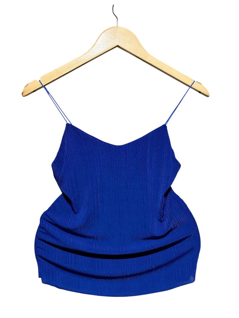 V-neck Pleated Blue Camisole Top (Category: Sleeveless) located in Cavite. Submitted by grandearth.39df3f (Listing ID 1470676547, Image 1). Description: - Color: Vibrant royal blue - Design: V-neck camisole with fine accordion pleats - Straps: Slender spaghetti straps - Fit: Relaxed drape with subtle gathered tiers at the hem - Material: Lightweight and breathable - Styling: Perfect to pair with jeans or skirts for warm weather.