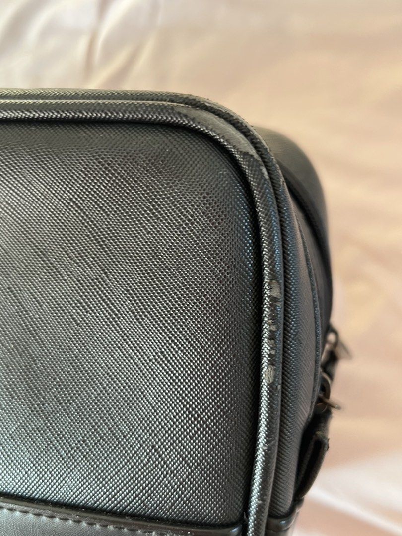 Volvik Golf Ball Bag (Category: Golf) located in Manila. Submitted by bye.ad (Listing ID 1470665300, Image 2). Description: - Color & Design: Black structured toiletry bag with a sleek V logo on the front - Material: Textured faux leather with a side handle strap for easy carrying - Compartments: Double zipper closure for organized storage - Condition: Clean interior space, minor scuffs along the side piping near the corner zipper - Perfect for f