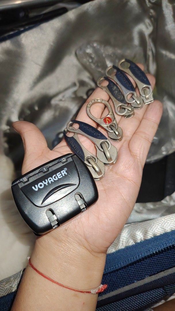 Voyager Combination Lock and Replacement Zipper Pulls Set (Category: Luggage) located in Manila. Submitted by purediamond888 (Listing ID 1470699911, Image 1). Description: - Authentic Voyager black combination lock with built-in dials - Includes matching metal and blue zipper pulls plus one round expander pull - Perfect replacement hardware for luggage, travel bags, and backpacks - Ideal for fixing missing or broken zippers - What you see in the 