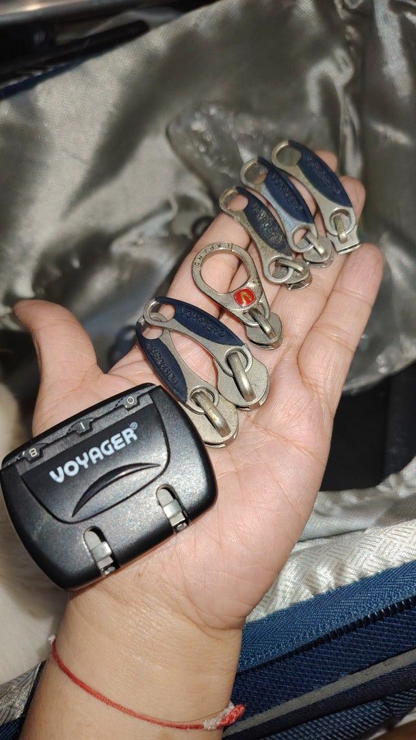 Voyager Combination Lock and Replacement Zipper Pulls Set (Category: Luggage) located in Manila. Submitted by purediamond888 (Listing ID 1470699911, Image 2). Description: - Authentic Voyager black combination lock with built-in dials - Includes matching metal and blue zipper pulls plus one round expander pull - Perfect replacement hardware for luggage, travel bags, and backpacks - Ideal for fixing missing or broken zippers - What you see in the 