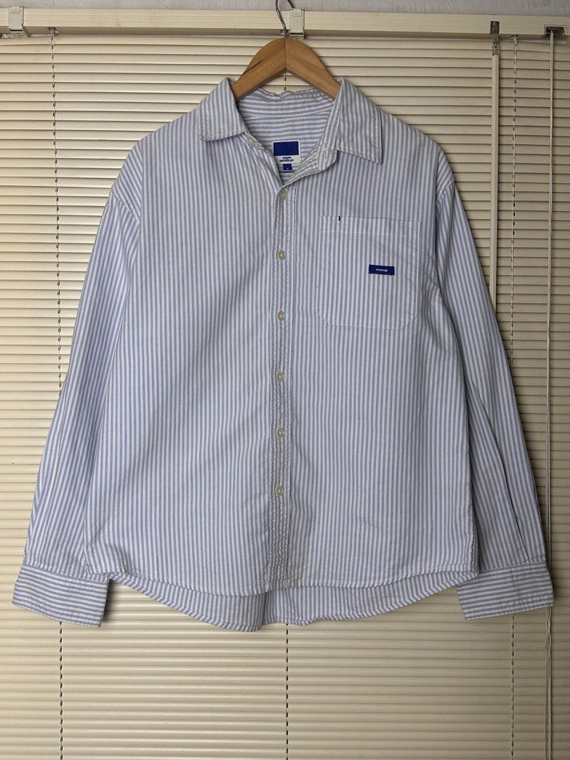 Wassup Blue and White Striped Button-Up Shirt (Category: Coats, Jackets and Outerwear) located in Santa Rosa. Submitted by shop818 (Listing ID 1470697982, Image 1). Description: Light blue and white vertical stripe shirt from Wassup. Collared neckline, button-down front, and a single chest pocket featuring a small brand logo label. Long sleeves with button cuffs. Back yoke has a small embroidered graphic detail and locker loop. Lightweight cotton