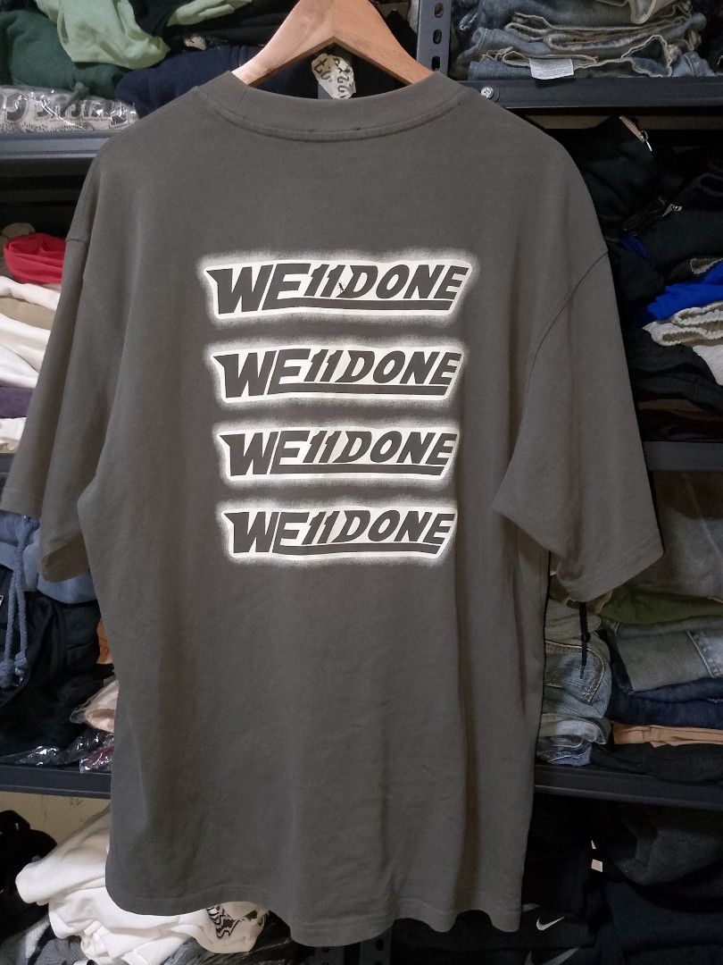 We11done Dark Grey Logo T-shirt (Category: Tshirts & Polo Shirts ) located in Manila. Submitted by mjthrifted_second (Listing ID 1470612207, Image 2). Description: - Brand: We11done - Color: Dark Grey - Size: Large (Oversized fit) -Dimes: 24/29.5 - Material: 100% Cotton, Made in Korea - Condition: Excellent/Clean, no stains or holes - Details: Small white logo patch on chest, four stacked logo prints on back, ribbed crew neck.