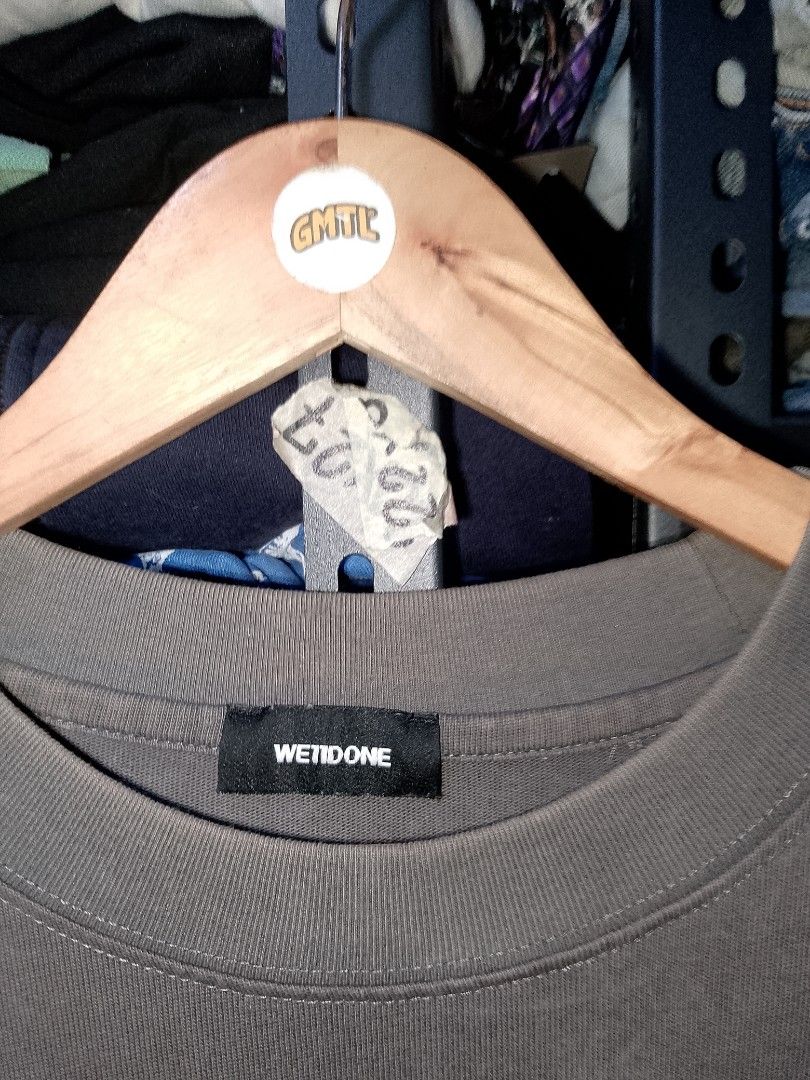 We11done Dark Grey Logo T-shirt (Category: Tshirts & Polo Shirts ) located in Manila. Submitted by mjthrifted_second (Listing ID 1470612207, Image 3). Description: - Brand: We11done - Color: Dark Grey - Size: Large (Oversized fit) -Dimes: 24/29.5 - Material: 100% Cotton, Made in Korea - Condition: Excellent/Clean, no stains or holes - Details: Small white logo patch on chest, four stacked logo prints on back, ribbed crew neck.