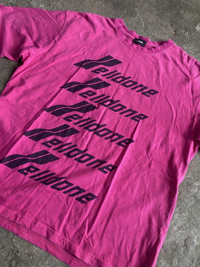 We11done Pink Repeated Logo T-Shirt (Category: Shirts) located in Caloocan City. Submitted by remythrift (Listing ID 1470589590, Image 2). Description: - Brand: We11done - Color: Bright pink with stacked black logo print - Size: Tagged M (oversized, fits like one-size) - Material: Cotton and polyester blend (Made in Korea) - Condition: Light wear from normal washing.