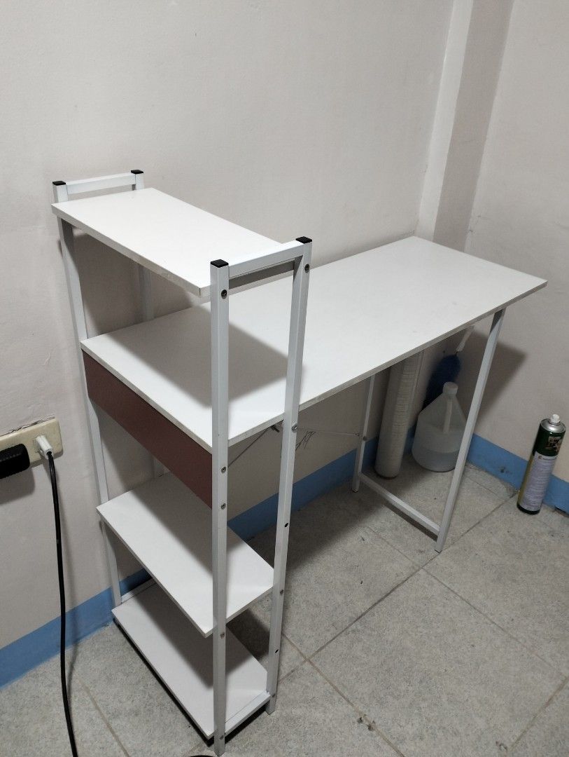 White Computer Desk with Attached Shelves and Bookshelf (Category: Tables & Sets) located in Paranaque City. Submitted by _andreaaaa13 (Listing ID 1470719376, Image 2). Description: bought for 928 will sell for 750. - Used for 1 year - Pinatungan lang ng mga gamit pang nails. - May mga minimal lang na stain but hindi sobrang halata. last 2 photos yan ang mga nakalagay. The buyer will shoulder the delivery fee. I can disassemble the table..
