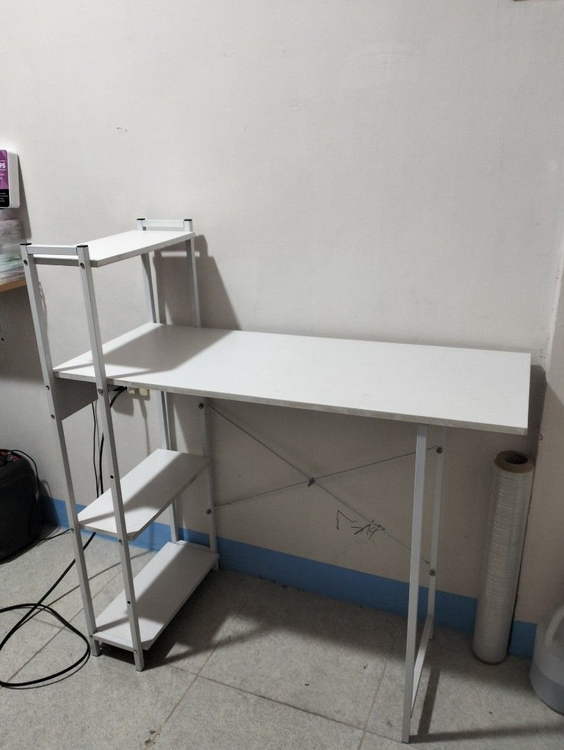 White Computer Desk with Attached Shelves and Bookshelf (Category: Tables & Sets) located in Paranaque City. Submitted by _andreaaaa13 (Listing ID 1470719376, Image 1). Description: bought for 928 will sell for 750. - Used for 1 year - Pinatungan lang ng mga gamit pang nails. - May mga minimal lang na stain but hindi sobrang halata. last 2 photos yan ang mga nakalagay. The buyer will shoulder the delivery fee. I can disassemble the table..