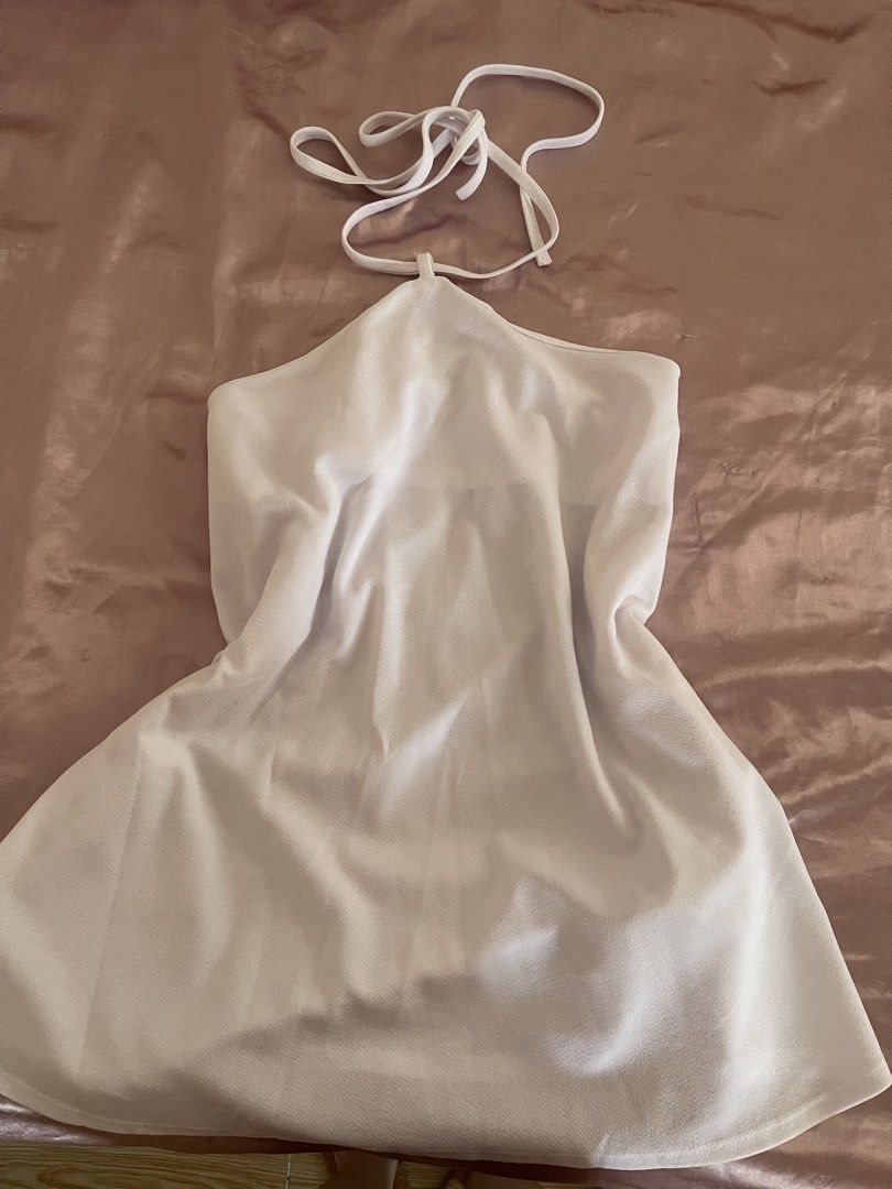 White Halter Neck Mini Dress (Category: Dresses) located in Manila. Submitted by lovedbymidge (Listing ID 1470647472, Image 1). Description: 🩷 for xs-m girlies 🚚 lalamove or grab express (sf shouldered by the buyer!) - Color: White - Design: Halter neck with self-tie straps and a sleeveless cut - Silhouette: Flared skirt hem - Material: Lightweight fabric with a smooth finish - Perfect for: Casual daytime outings, vacations, and warm weather - 