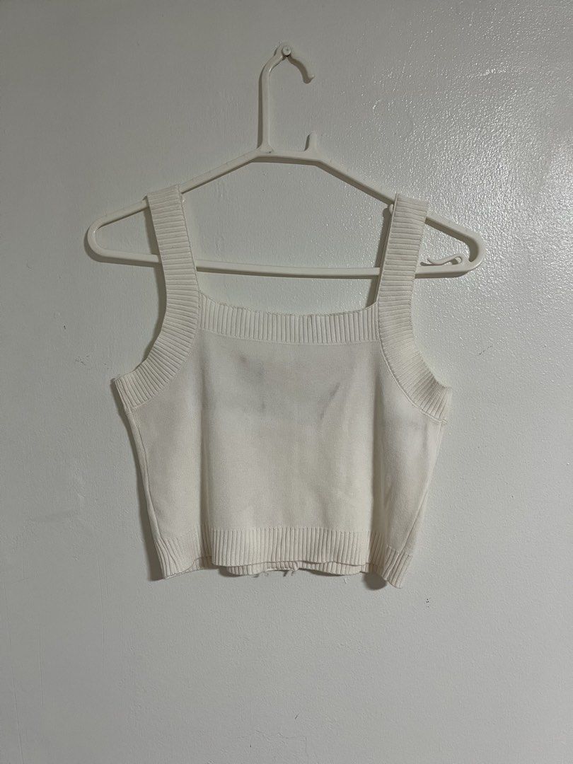 White Knitted Crop Tank Top with Buttons (Category: Sleeveless) located in Cabuyao City. Submitted by rdtrmt (Listing ID 1470743054, Image 3). Description: - Color: White - Style: Knitted crop top with square neckline and wide straps - Details: Front button closure with three metallic-rimmed buttons and ribbed trim - Fabric: Soft textured knit - Fit: Versatile basic piece, great for layering or wearing on its own - Pairing: Easily matches high-wa
