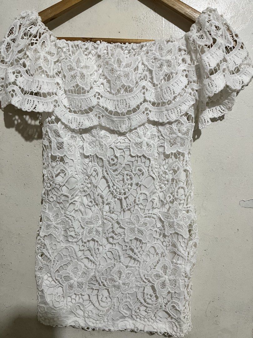 White Off-Shoulder Lace Mini Dress (Category: Dresses) located in Manila. Submitted by elocin_0428 (Listing ID 1470563498, Image 3). Description: White off-shoulder mini dress with floral lace overlay, ruffled flounce, and a bodycon fit.!.