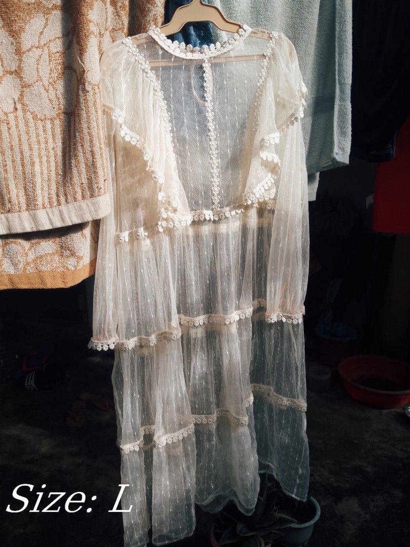 White Sheer Lace Tiered Maxi Dress (Category: Dresses) located in Naga. Submitted by francethriftee3 (Listing ID 1470670314, Image 1). Description: Location: Camarines Sur, Bicol - Style: White sheer tiered maxi dress - Size: Large - Details: Delicate lace trim, ruffle accents on the front bodice, button closure at the neckline - Sleeves: Long sleeves - Fabric: Lightweight mesh - Versatility: Great beach cover-up or warm-weather layering piece.