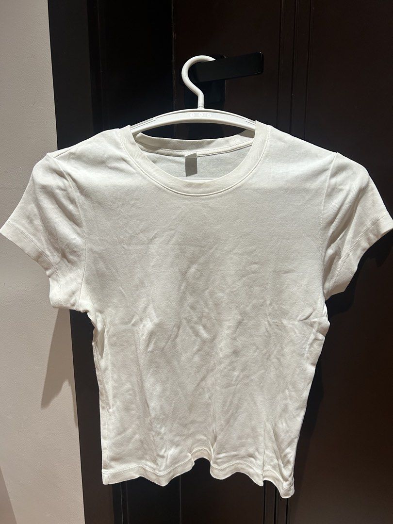 White Short Sleeve Fitted Tee Shirt (Category: Shirts) located in Davao. Submitted by lachisoo_ (Listing ID 1470711371, Image 1). Description: - Color: White but slightly discolored - Fit: Fitted with a slightly cropped hem - Material: Super soft and breathable cotton - Details: Short sleeves and crew neckline - Styling: Easy to pair with high-waisted jeans, shorts, or skirts for any casual daily outfit.