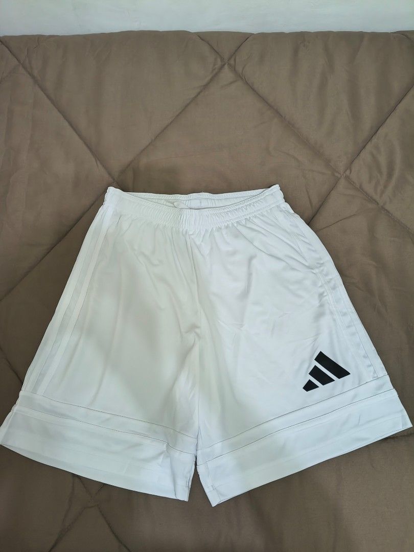 White Sports Shorts (Category: Activewear) located in Mandaluyong City. Submitted by yeojdurangorecto (Listing ID 1470630840, Image 2). Description: - Brand: Adidas - Color: White with black logo on lower right leg - Material: Lightweight fabric, ideal for workouts and casual wear - Waist: Elastic waistband with adjustable drawstring - Measurements: 30cm waist width, 42cm length, 30cm leg opening - Condition: Excellent RUSH ITEM!!! ONE PIECE ONLY