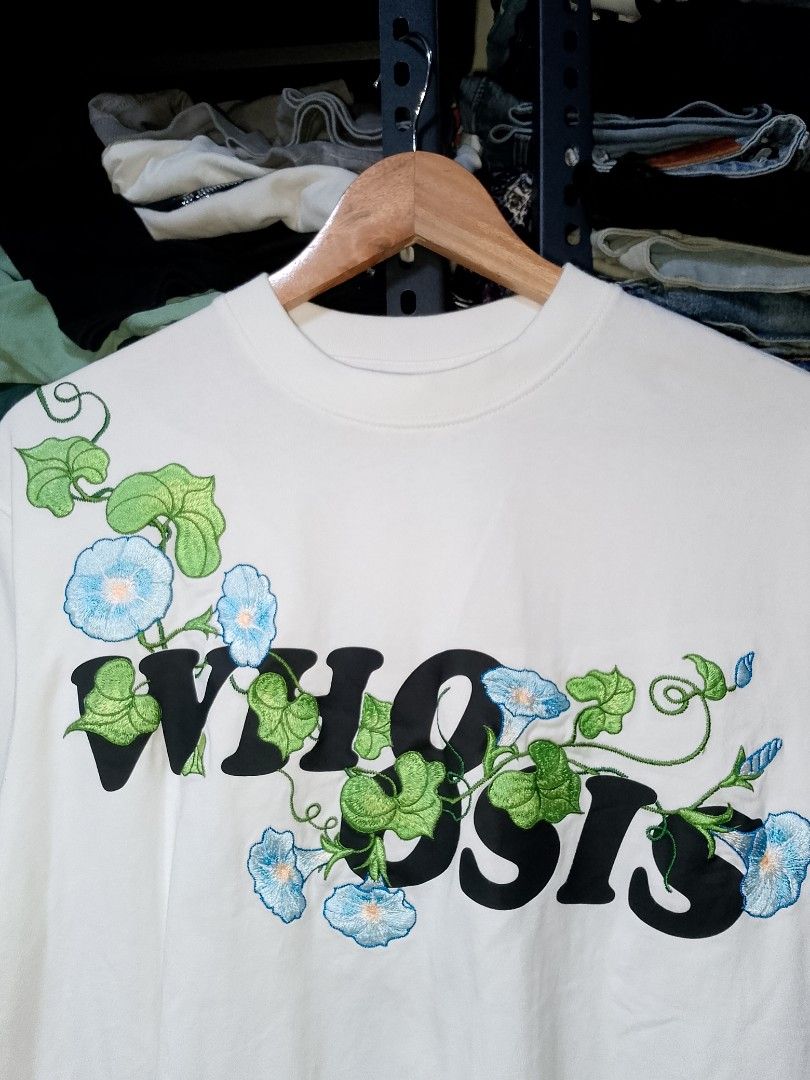 Whoosis Embroidered Floral White Tee (Category: Tshirts & Polo Shirts ) located in Manila. Submitted by mjthrifted_second (Listing ID 1470608513, Image 2). Description: - Brand: Whoosis -Size: Small -Dimes: 22/28 - Color: White with blue morning glory flowers and green vines - Material: 100% cotton - Design: Detailed floral embroidery and bold black typography on front and back - Fit/Style: Short sleeves, crew neck.