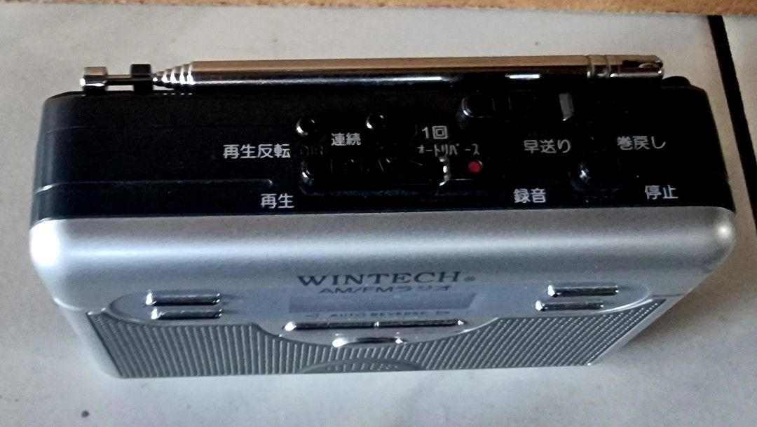 WINTECH AM/FM Radio Auto Reverse Portable Cassette Player (Category: Portable Music Players) located in Davao. Submitted by joee.joee (Listing ID 1470626705, Image 2). Description: - Brand: WINTECH - Type: Cassette player with built-in AM/FM radio - Color: Silver and black finish - Key Features: Auto reverse, digital display, built-in speaker, microphone, and telescopic antenna - Convenience: Attached belt clip on the back for easy portability - 