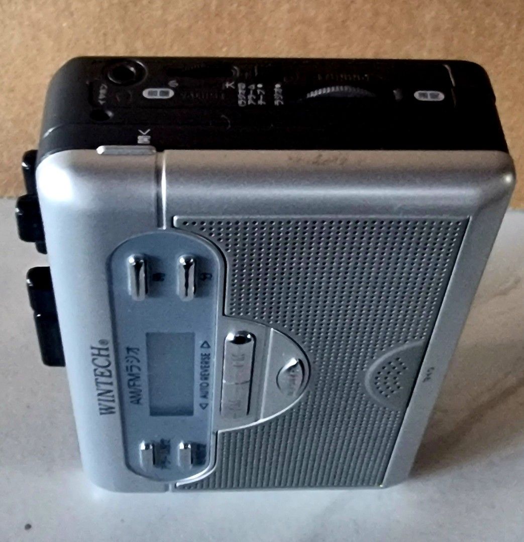 WINTECH AM/FM Radio Auto Reverse Portable Cassette Player (Category: Portable Music Players) located in Davao. Submitted by joee.joee (Listing ID 1470626705, Image 3). Description: - Brand: WINTECH - Type: Cassette player with built-in AM/FM radio - Color: Silver and black finish - Key Features: Auto reverse, digital display, built-in speaker, microphone, and telescopic antenna - Convenience: Attached belt clip on the back for easy portability - 
