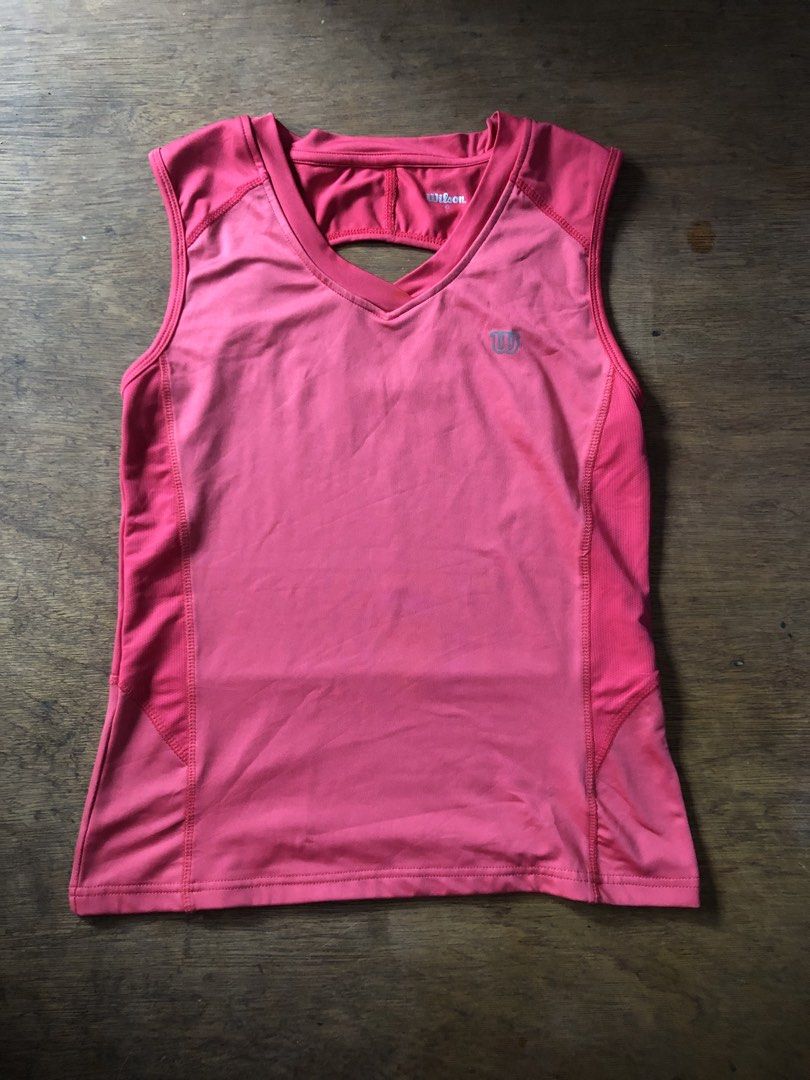 Wison Athletic Tank top (Category: Activewear) located in Davao. Submitted by blufinds (Listing ID 1470638110, Image 3). Description: This image shows a bright pink women’s athletic tank top from Wilson featuring a V-neck, sleeveless cut, and a cross-strap back detail..