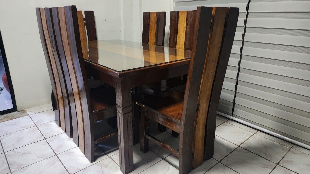 Wooden Dining Table Set with Six Chairs (Category: Tables & Sets) located in Taguig. Submitted by arnoldcb.800 (Listing ID 1470567737, Image 1). Description: - Set includes: 1 solid wood dining table and 6 matching chairs - Tabletop protection: Smooth glass cover included - Design: Sturdy multi-tone wood panels with dark and natural brown finishes - Capacity: Comfortably seats 6 people - Style: Clean modern rustic look, perfect for any dining spa