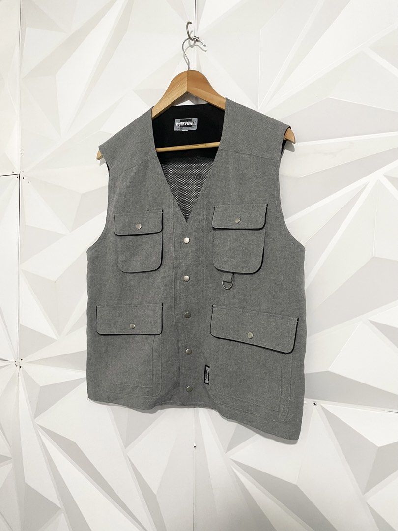 Work Power Grey Utility Vest Size L (Category: Vests) located in Cabuyao City. Submitted by ParadisethriftedPh (Listing ID 1470729641, Image 2). Description: Cr: 9.8/10 Dimensions W: 21 L: 24 - Brand: Work Power - Size: L - Color: Grey with black mesh lining - Features: Multiple front pockets with button flaps, small D-ring on the right chest, breathable mesh back - Closure: Front button - Condition: Clean, great pre-loved condition - Style: Perf