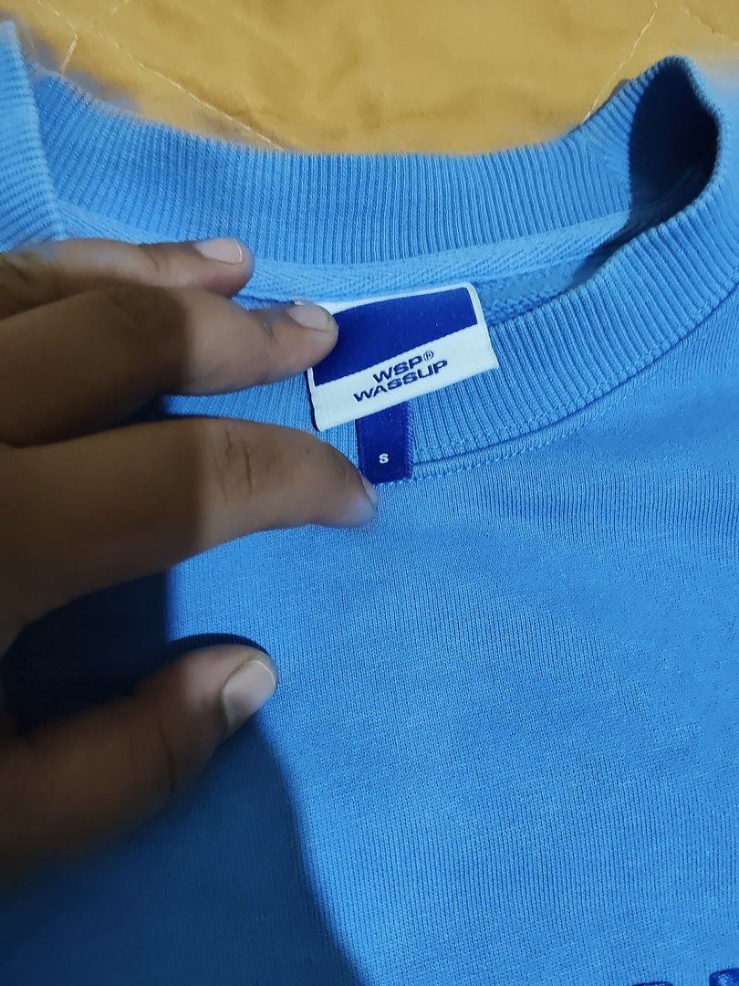 WSP Wassup Blue Sweatshirt Size S (Category: Coats, Jackets and Outerwear) located in Caloocan City. Submitted by jalexisjoy47916 (Listing ID 1470723373, Image 3). Description: - Brand: WSP Wassup - Size: Small - Color: Blue with matching blue embroidered lettering across the chest - Lining: Thick fleece for warmth and comfort - Details: Ribbed collar, cuffs, and hem - Style: Casual everyday pullover.